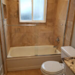 Bathrooms - Granite Shower, Floor and Counter Top at Cole Street Property by The Beautiful Home Company