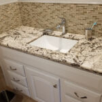 Bathrooms - Granite Counter Top and Tile Back Splash at Cole Street Property by The Beautiful Home Company